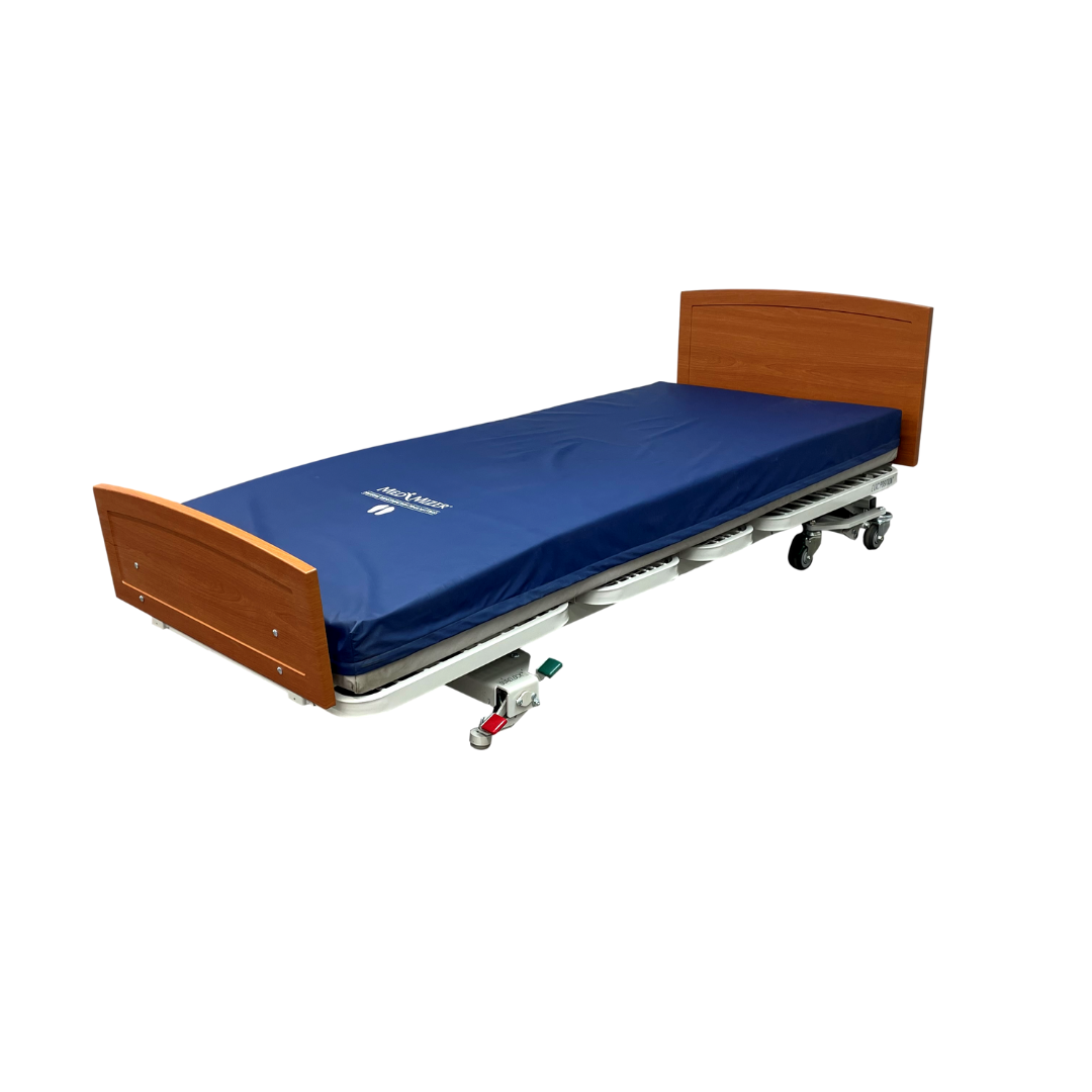 A space-saving safety design, the Med-Mizer RetractaBed Bariatric Hi/Low Electric Bed is width adjustable with a wooden headboard and footboard, blue mattress, and wheels for mobility, shown against a plain white background.